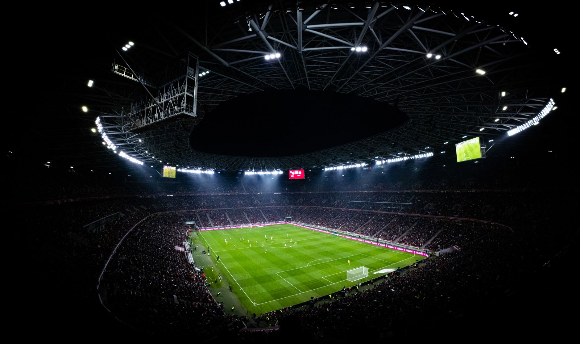 Aerial view of a night football match in Budapest. Illuminated stadium full