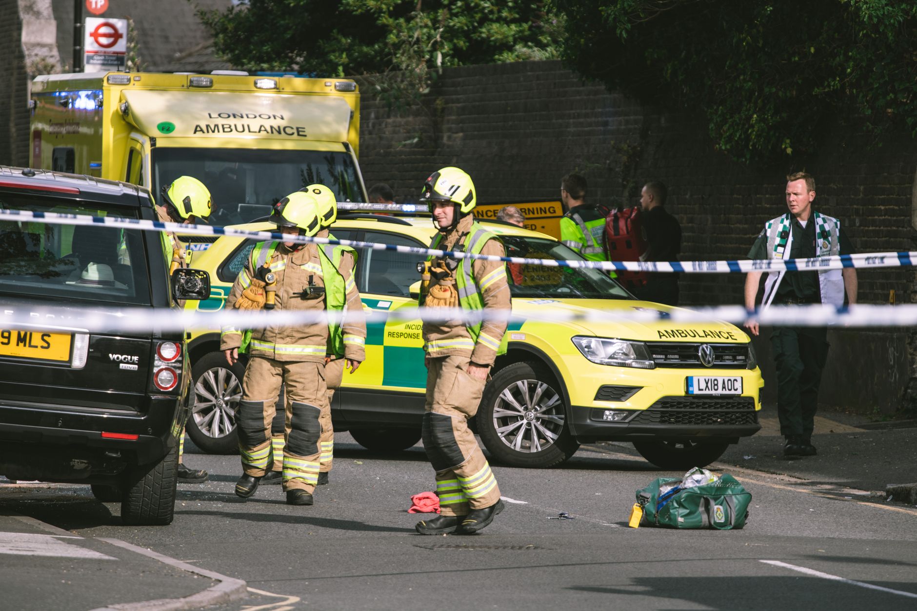 Firefighters and paramedics at a London street accident, featuring emergency vehicles and