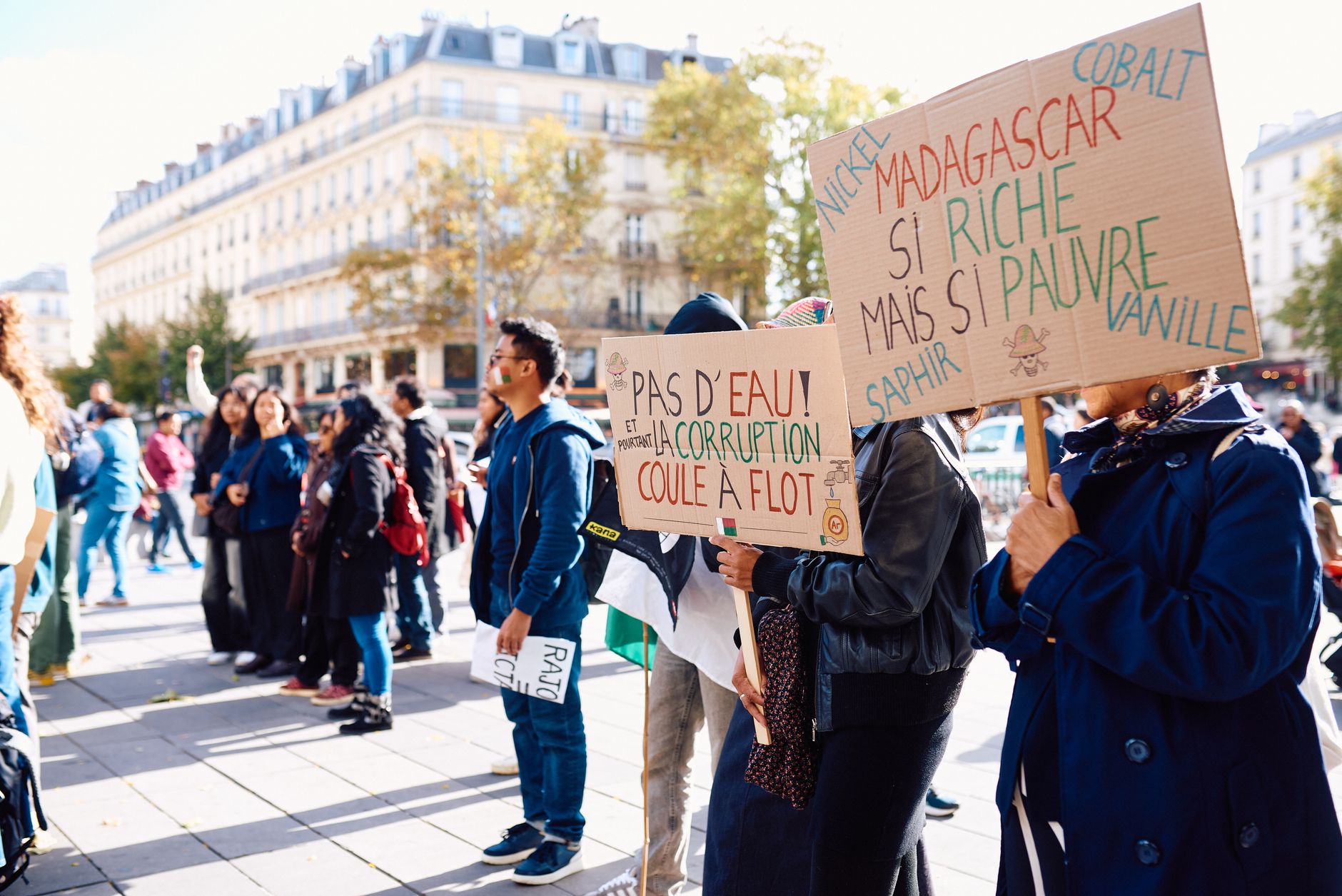 Crowd gathering for a peaceful protest in Paris, raising awareness about Madagascar's