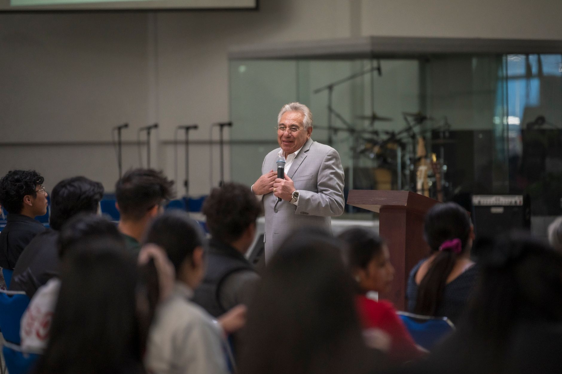 Speaker delivers engaging lecture in university hall to attentive audience with musical