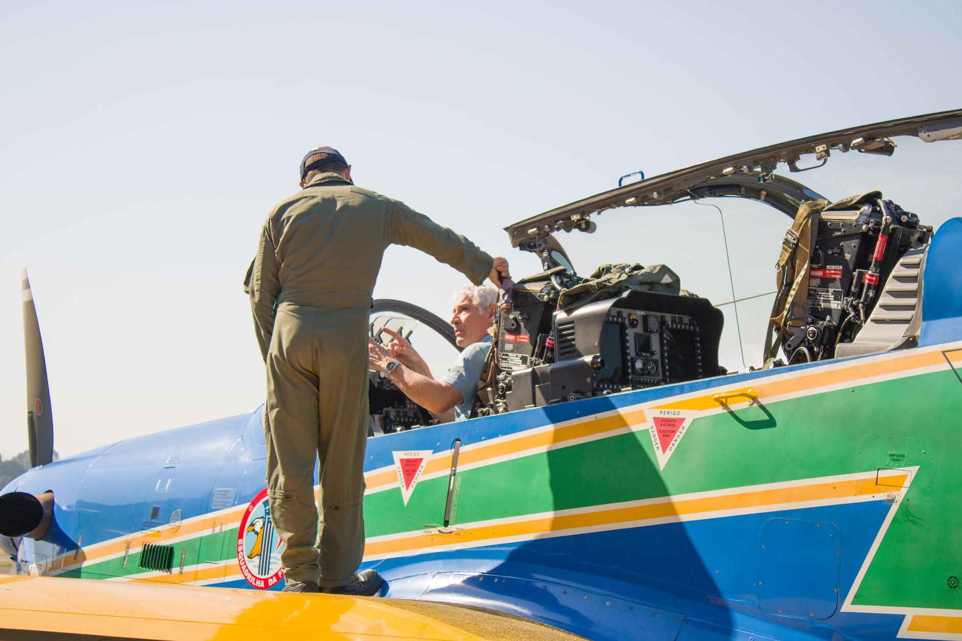 A military pilot standing by a vibrant aircraft, preparing for a mission