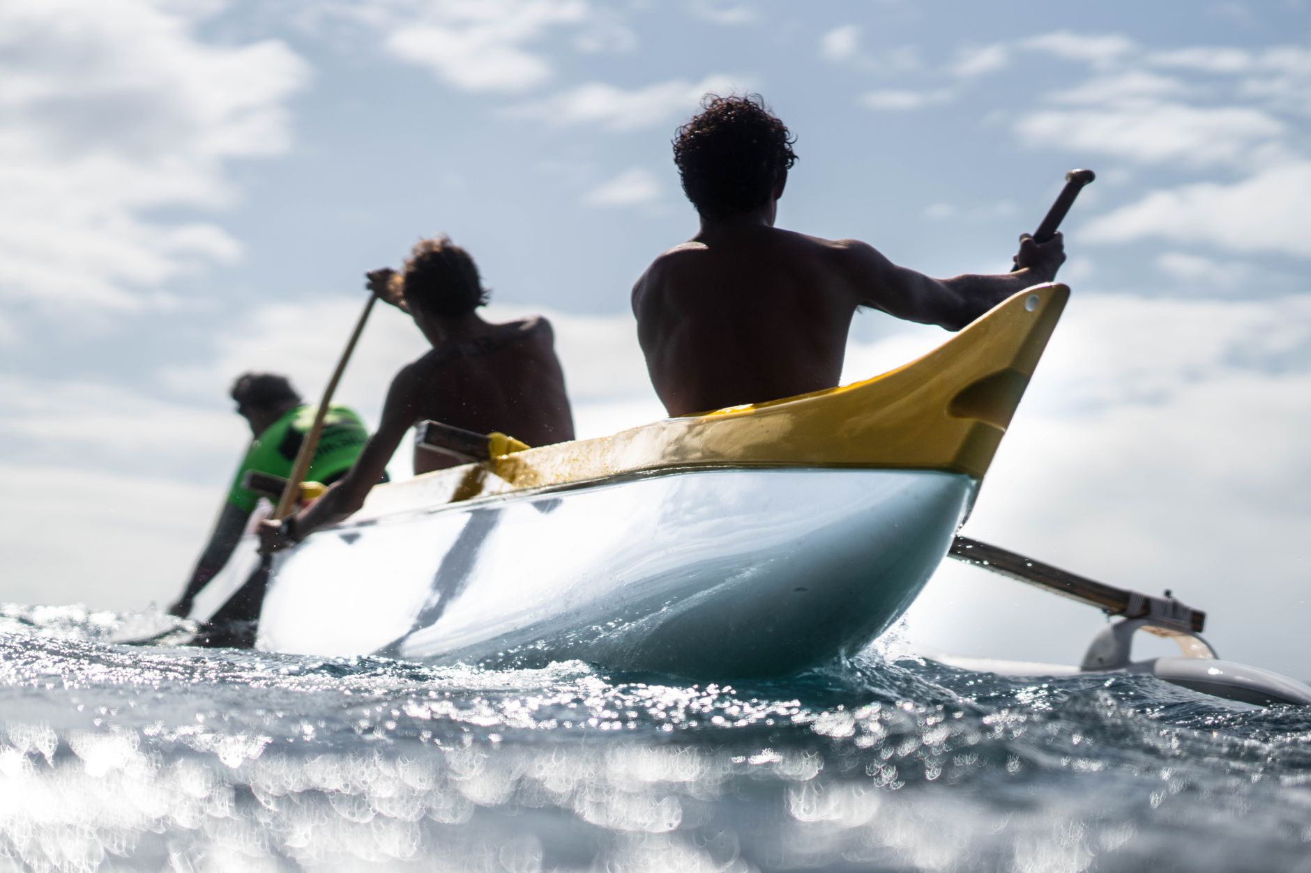 Captivating scene of canoeists paddling on the ocean, showcasing adventure and teamwork.