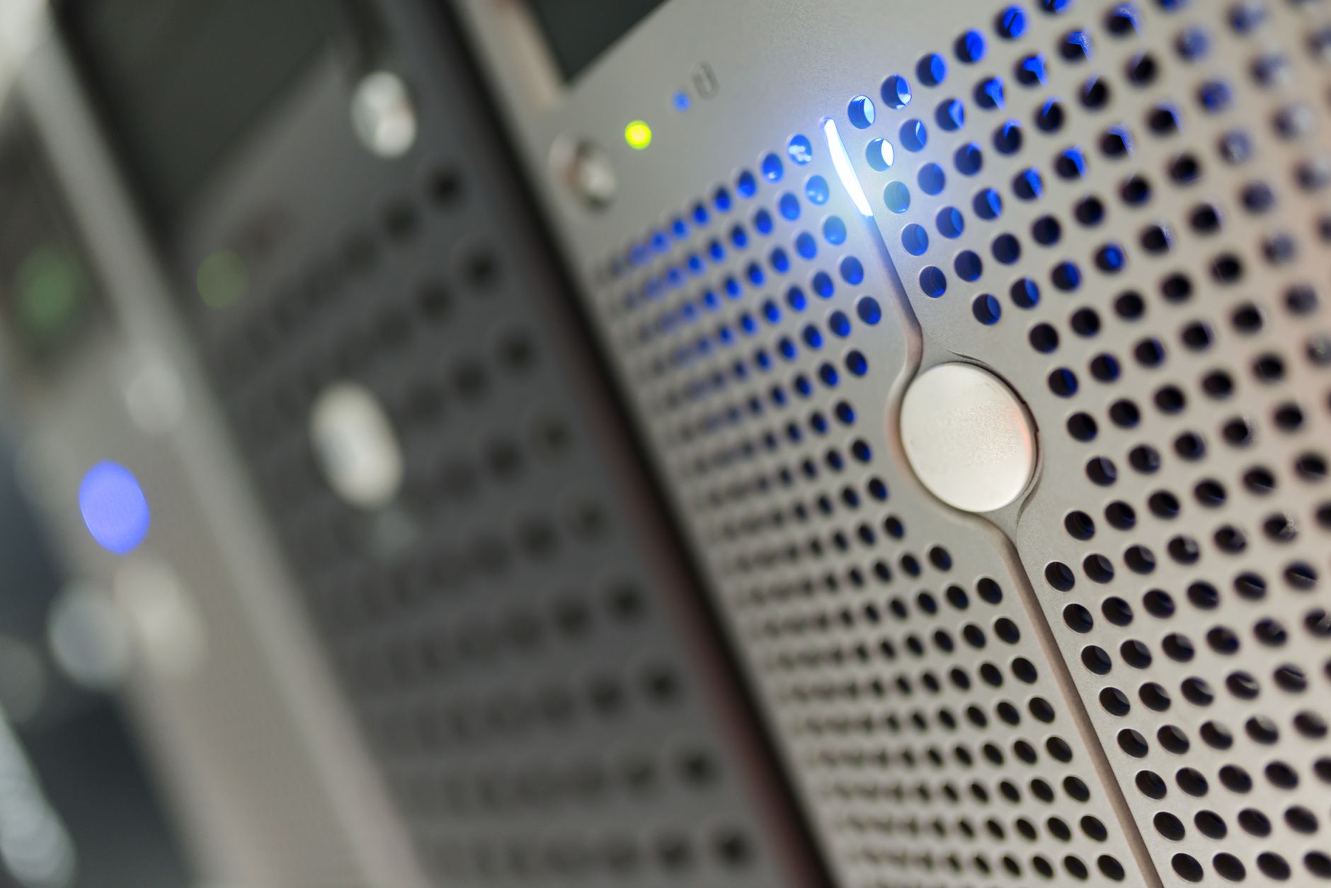Focused detail of a modern server rack with blue LED indicators in