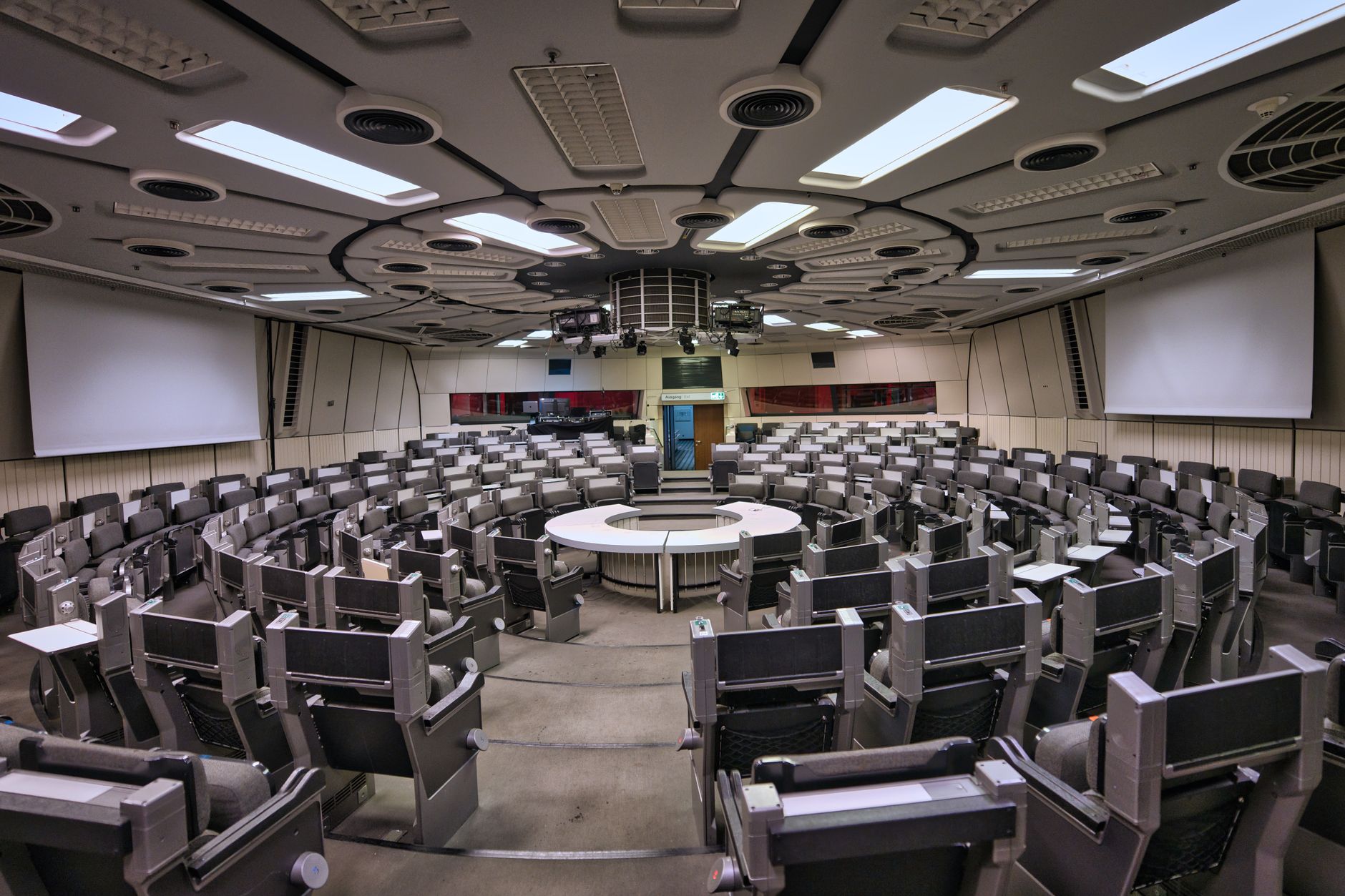 Empty futuristic conference room in Berlin ICC with circular seating and high-tech