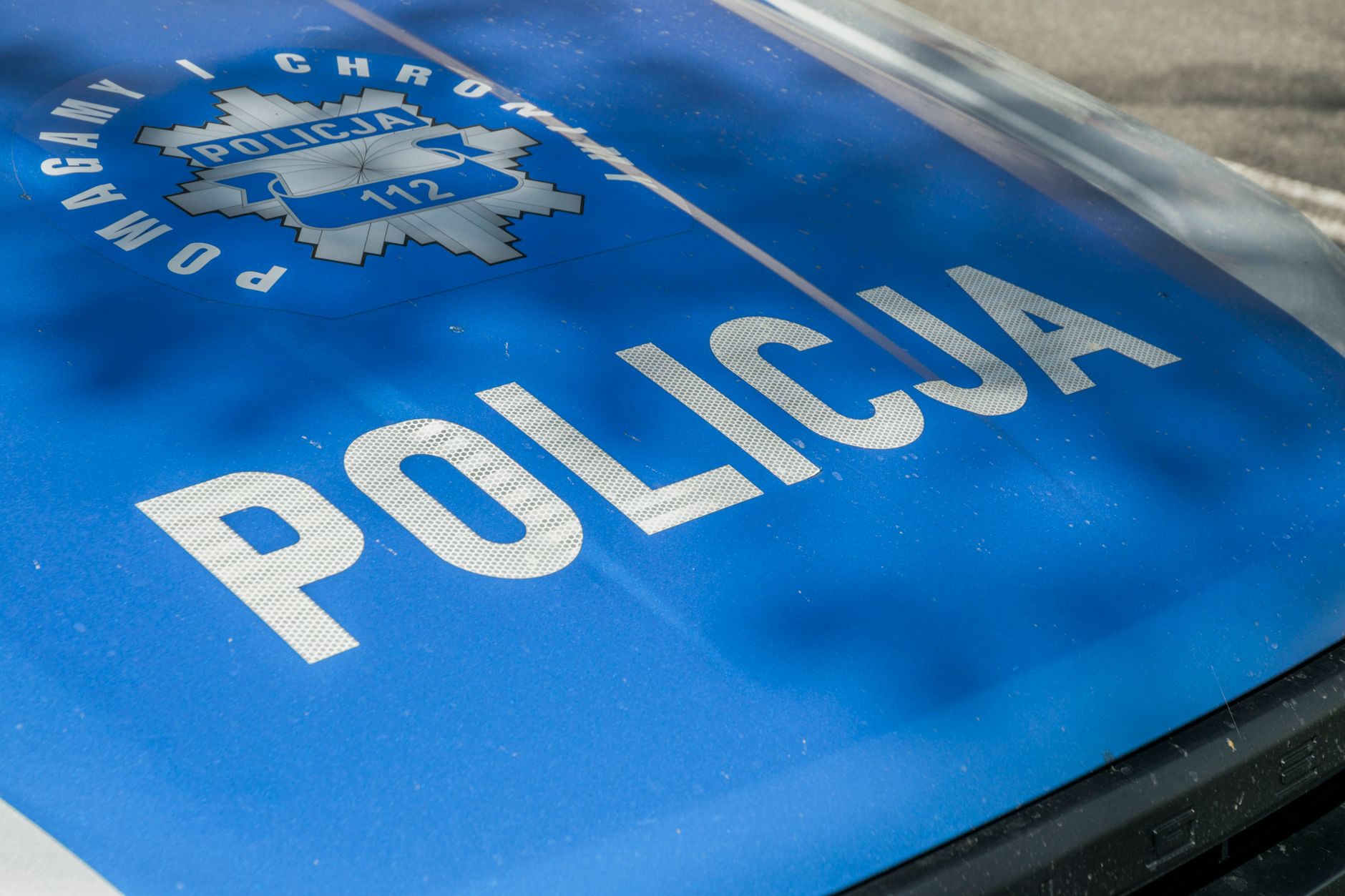 Detailed image of a Polish police car hood showing insignia and text