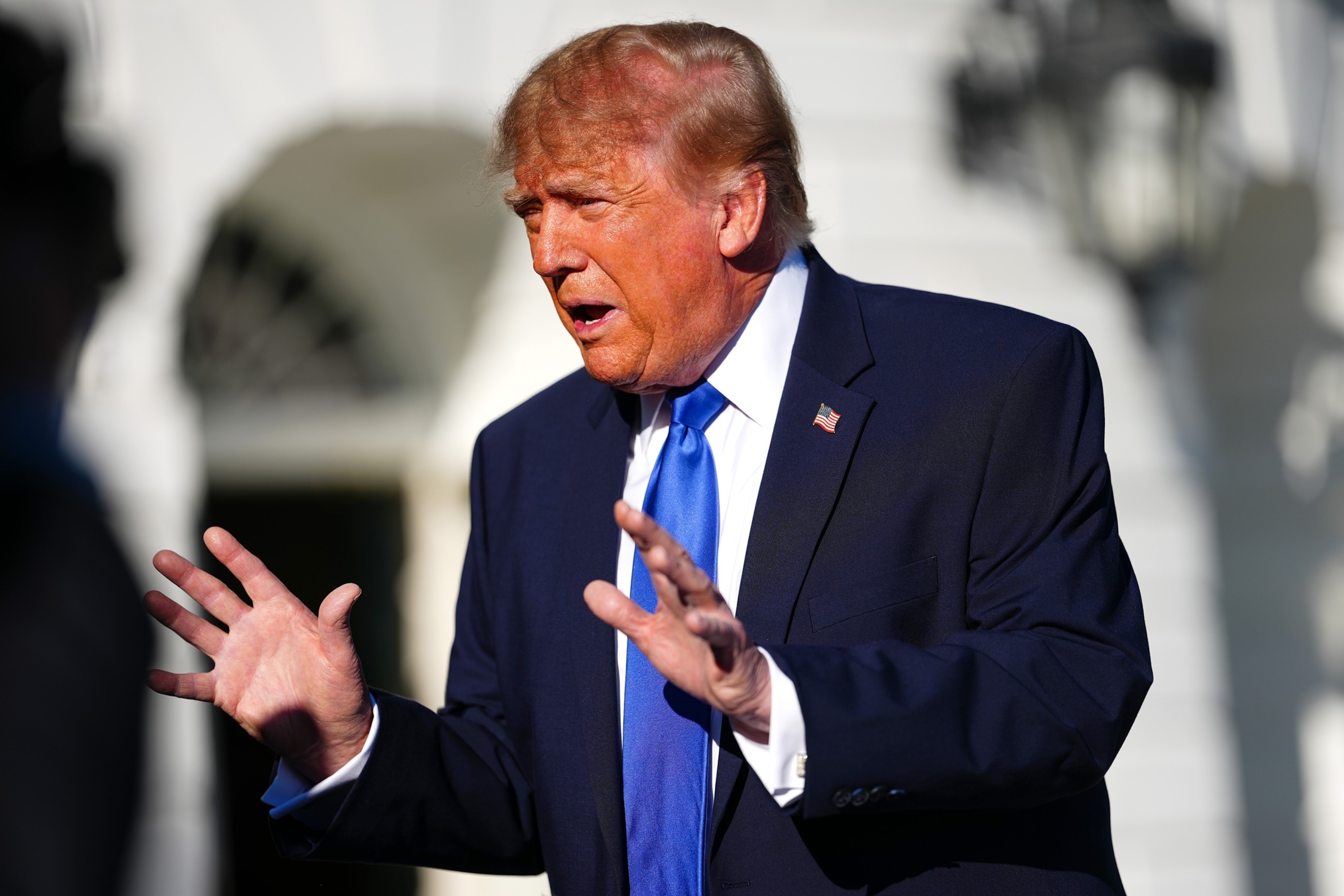 President Donald Trump speaks with reporters before walking to board Marine One