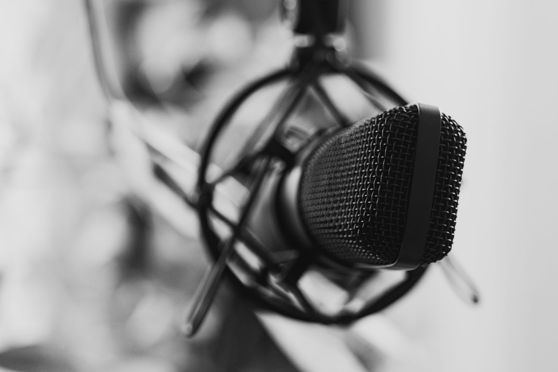 Close-up of a studio microphone with selective focus in black and white.