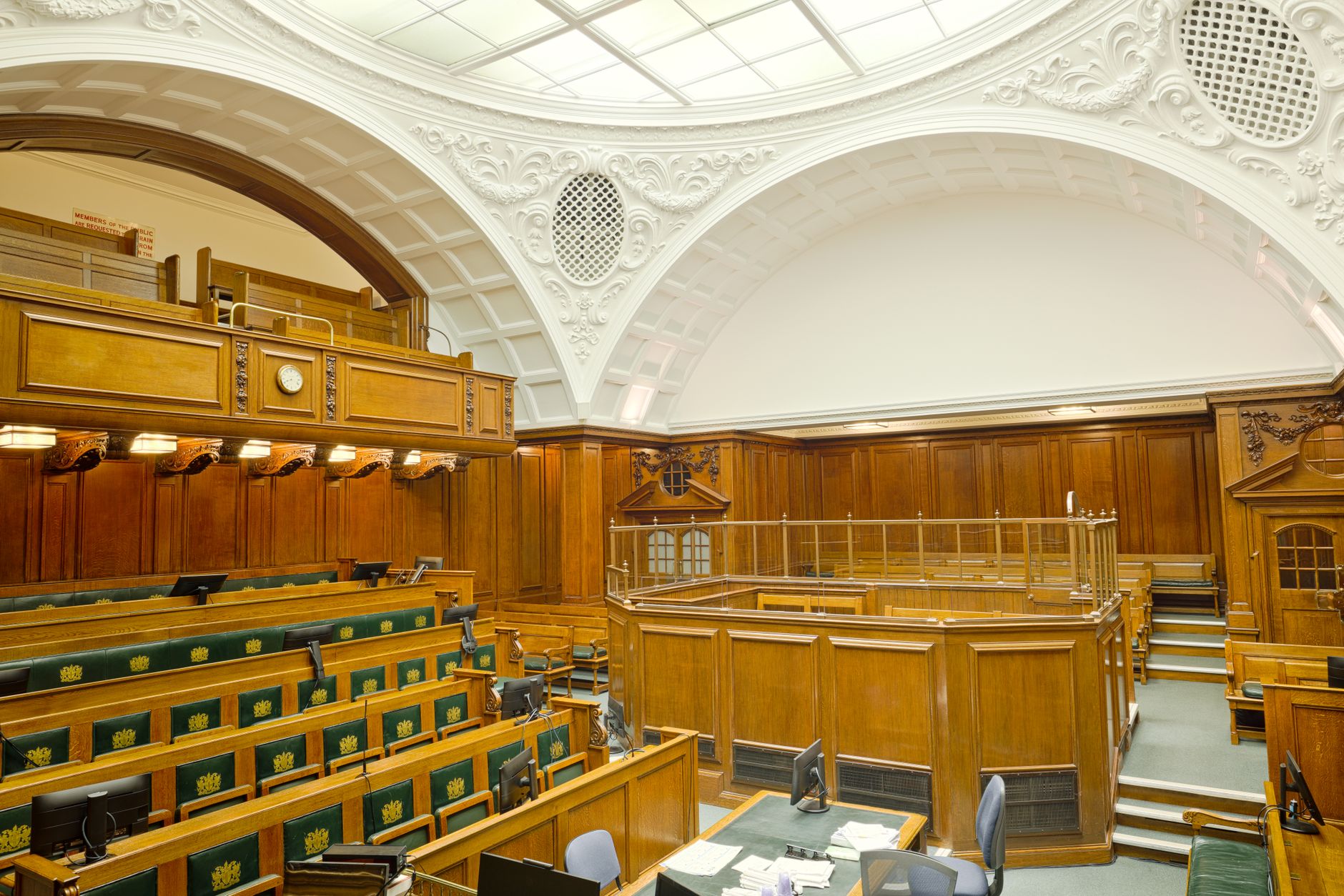 Interior view of a historic courtroom in London with ornate design and