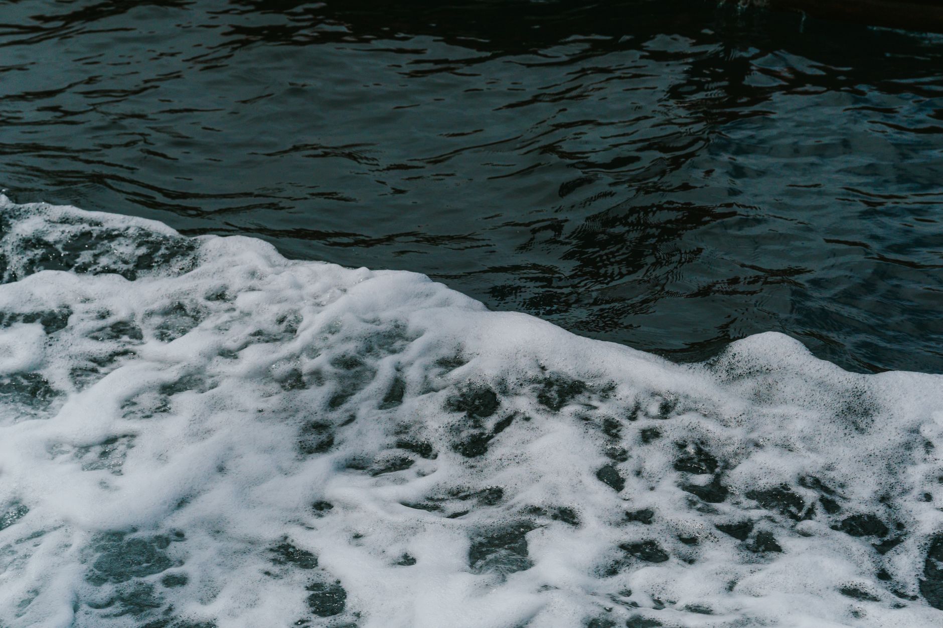 Captivating image of ocean waves creating frothy white foam, showcasing nature's dynamic motion.