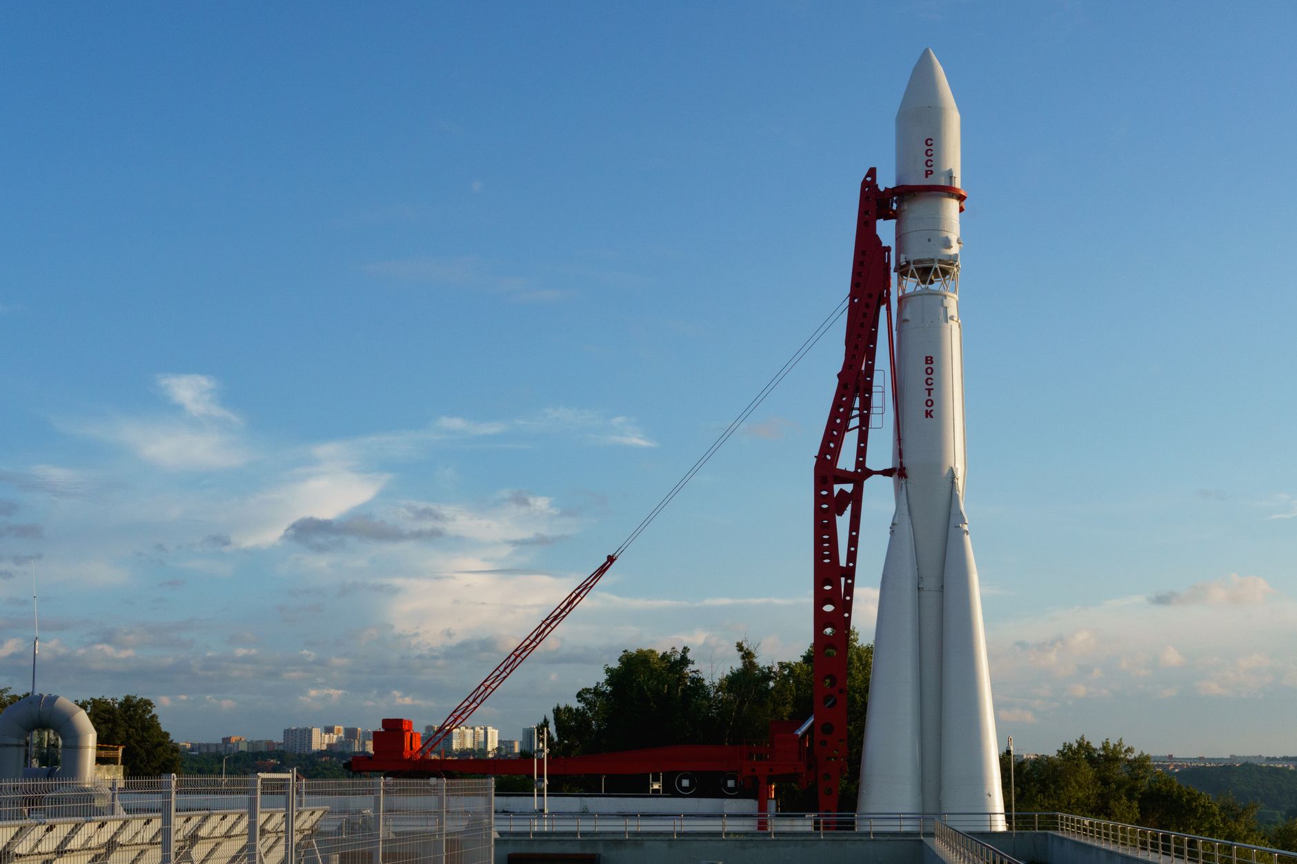 Vostok rocket stands poised on launch pad under clear blue sky at