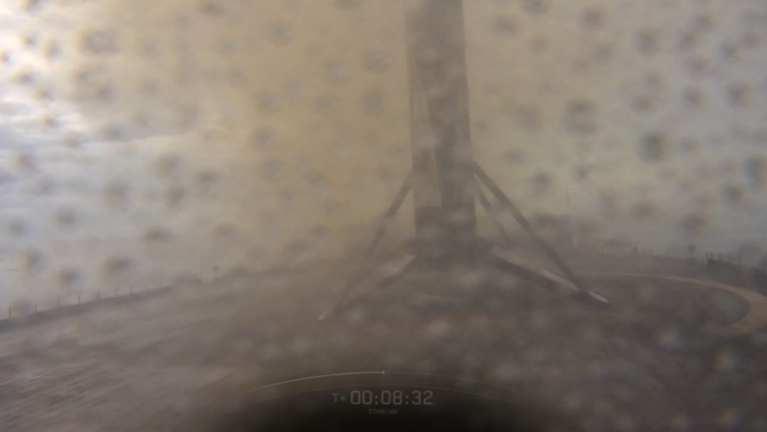 A sooty SpaceX rocket stands on an ocean drone ship platform after