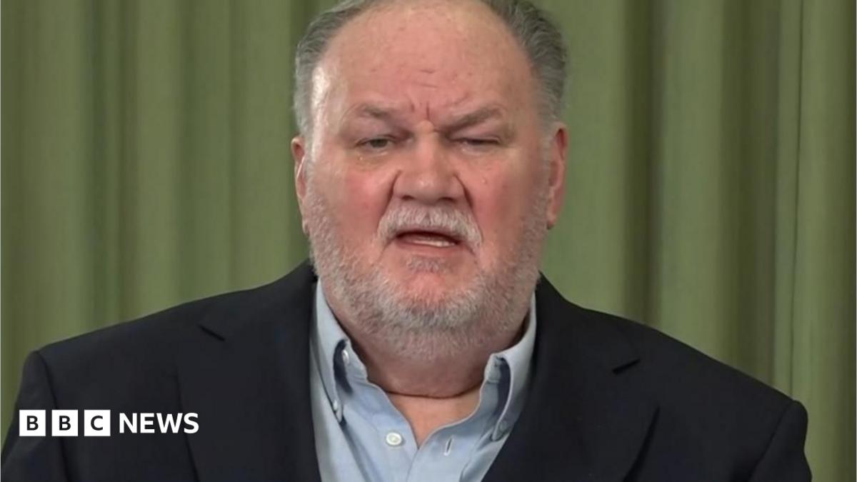 Thomas Markle, an older white man with grey hair and a short white beard. He is wearing a dark blue suit jacket and light blue shirt.