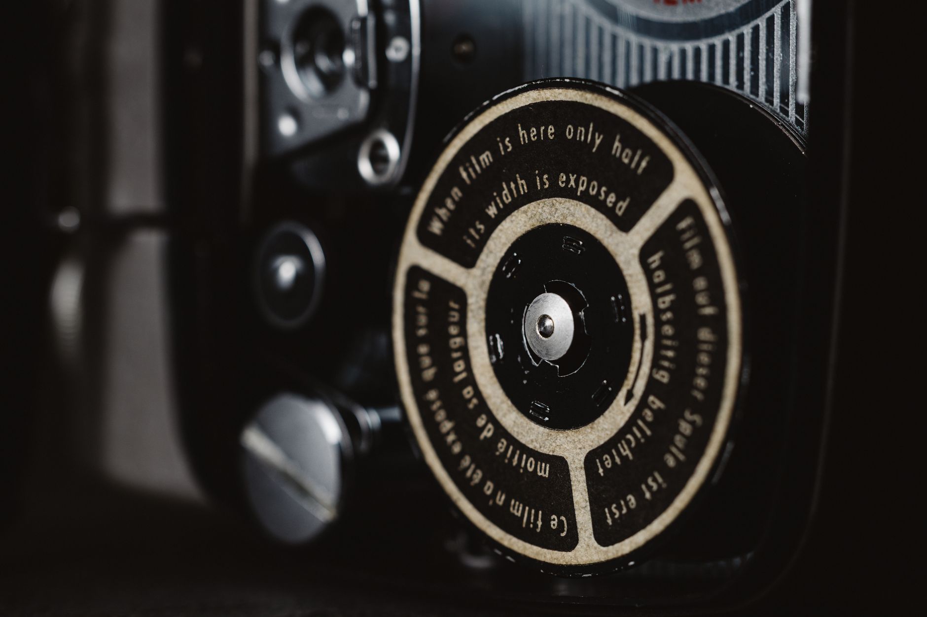Detailed view of a classic camera film mechanism with text on the