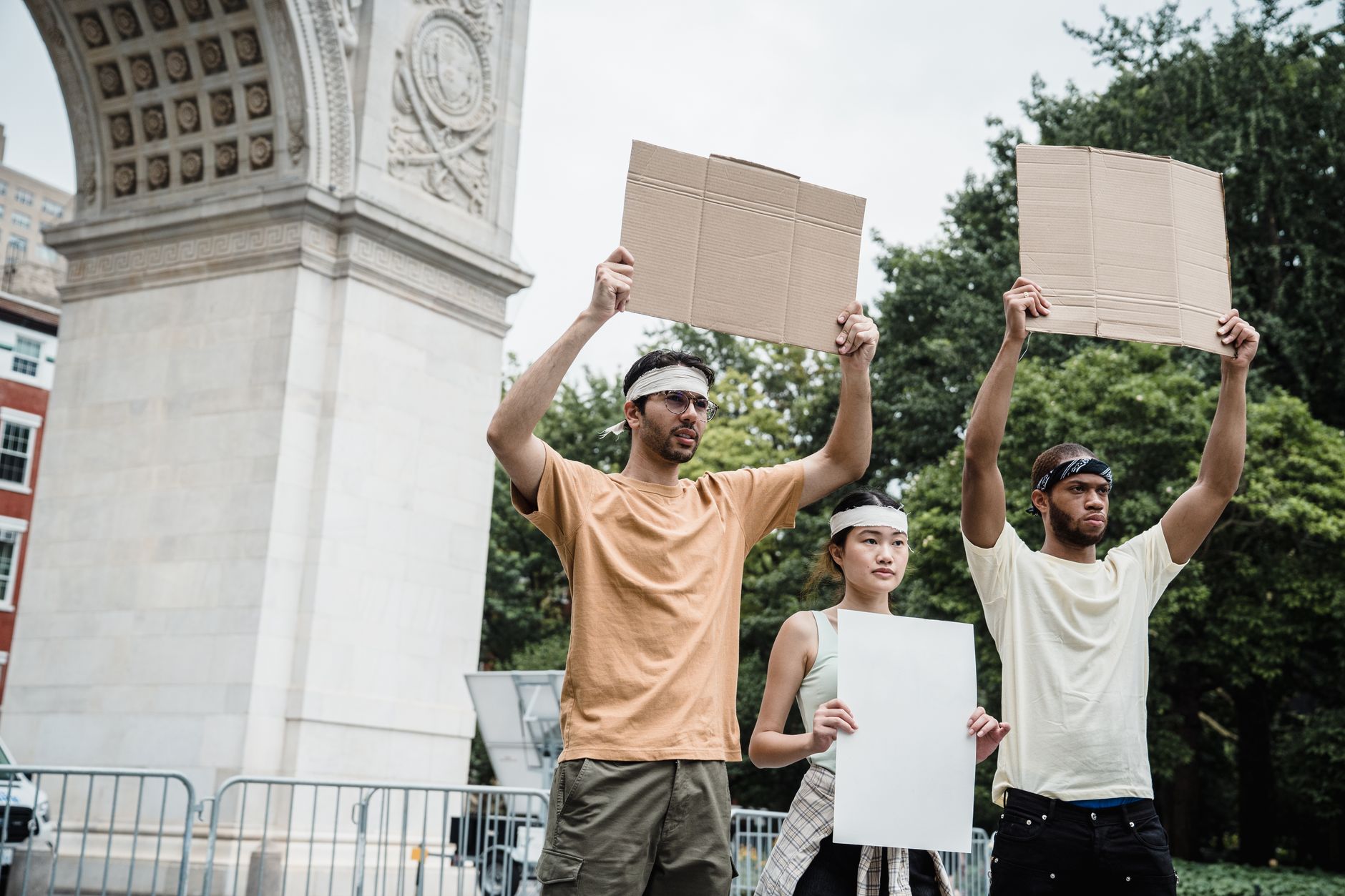 Group of diverse activists holding blank signs in a peaceful protest at