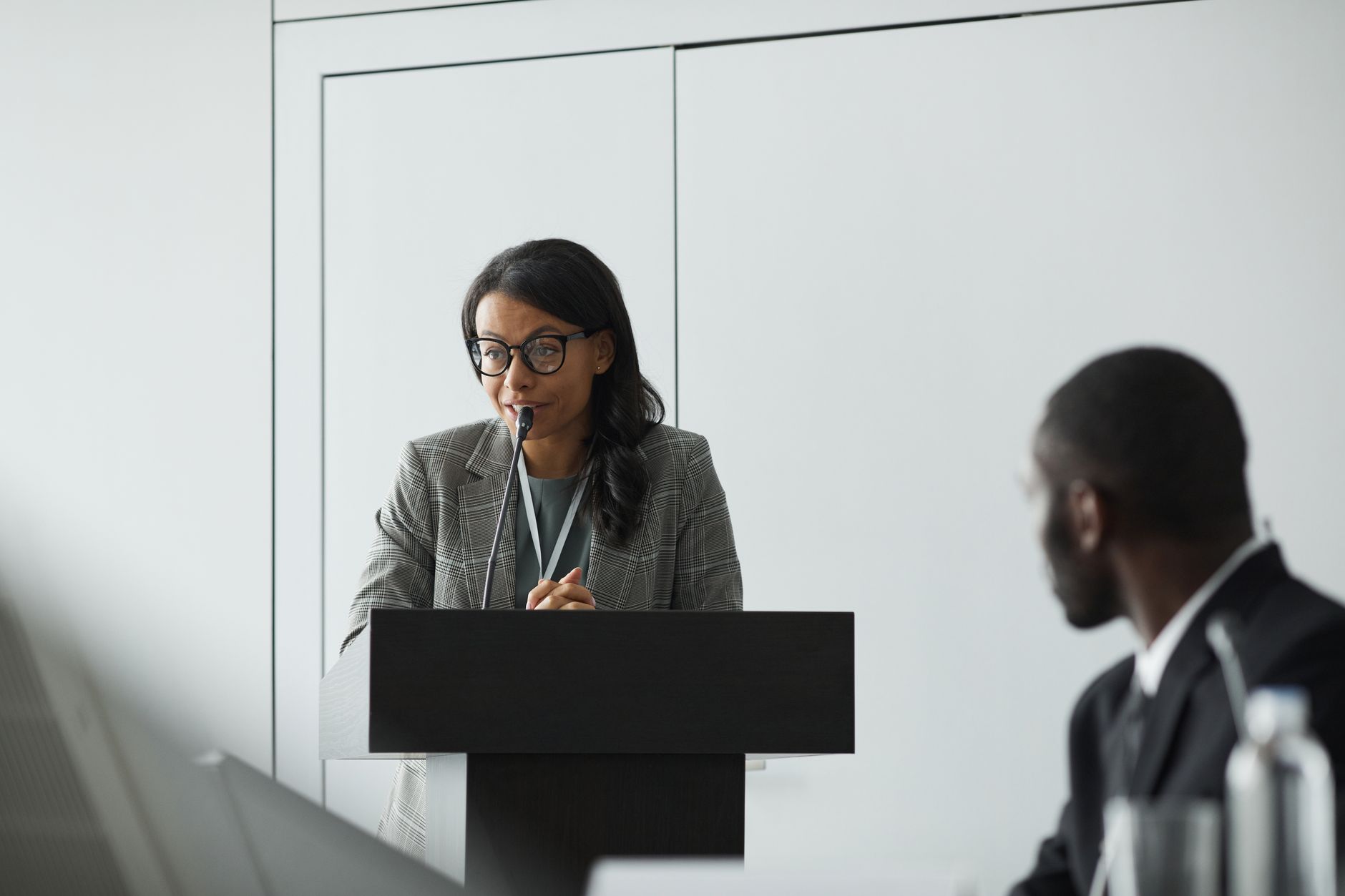 African American businesswoman delivering a speech at a conference podium with a