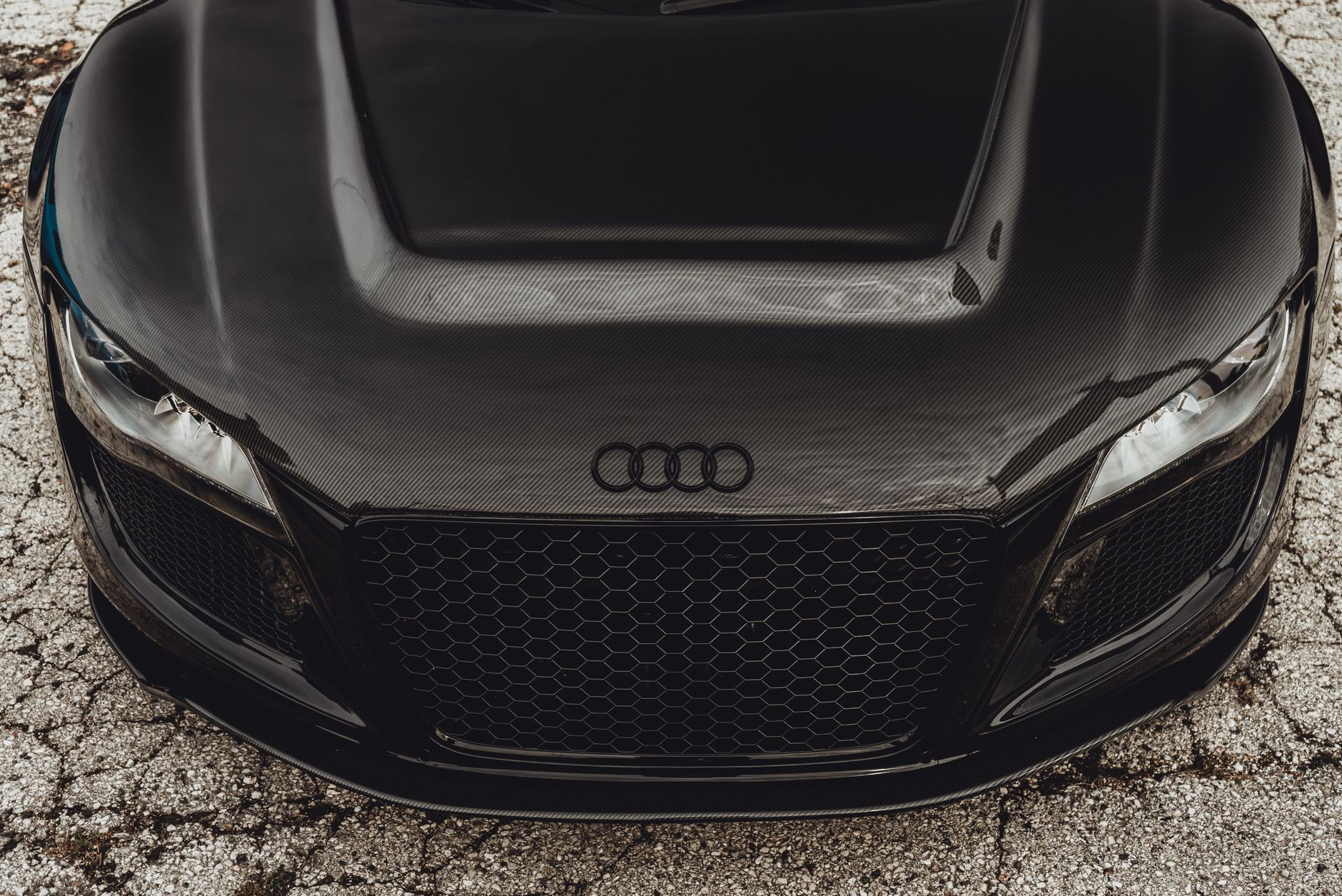 Detailed front view of a black Audi R8 supercar showcasing its carbon