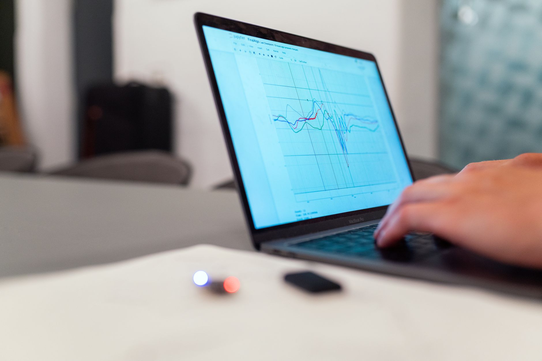 A person working on a graph analysis on a laptop for data