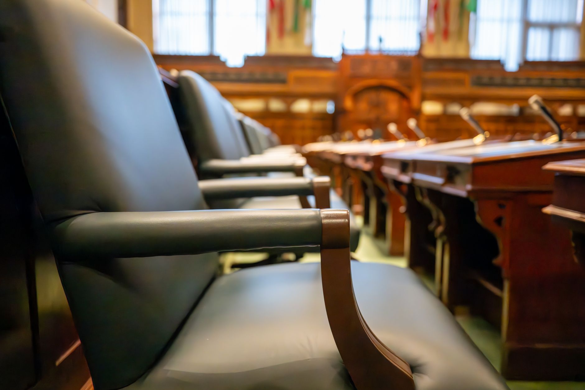 Elegant courtroom seating with leather chairs and wooden desks, exuding a sense