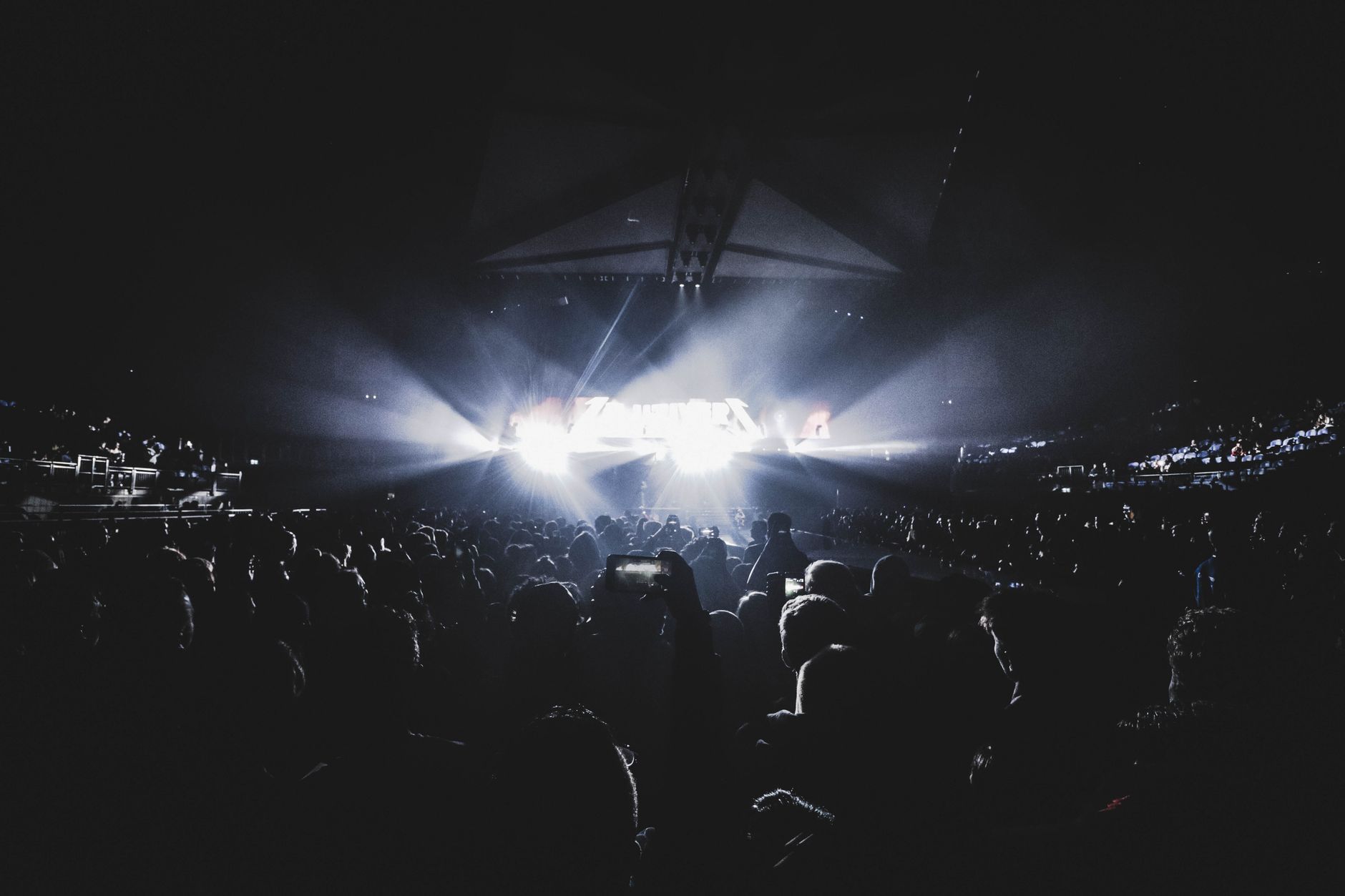 Dynamic concert scene with an energetic crowd at night in a London
